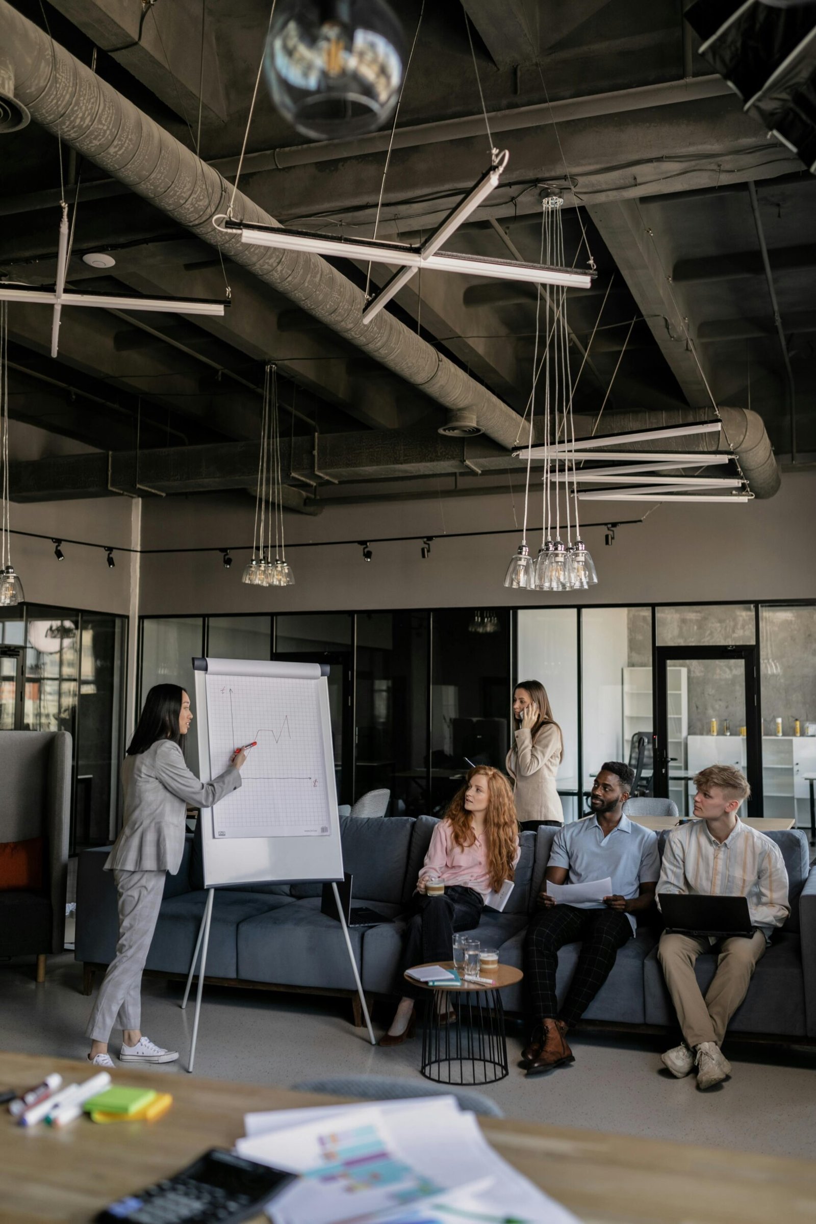 Colleagues brainstorm during a business meeting in a stylish office space.
